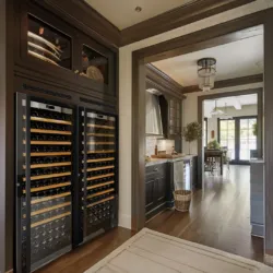 A luxurious kitchen with two Transtherm wine fridges stored in custom millwork.