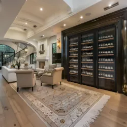 A luxurious living room with three Transtherm wine fridges stored in custom millwork.