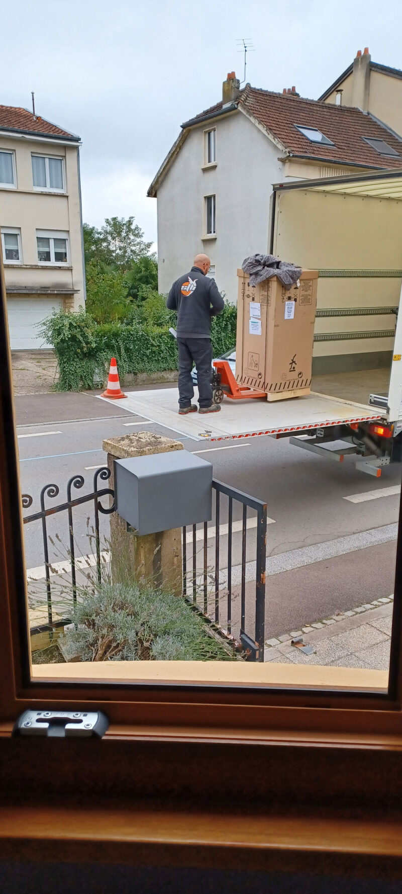 Goguette White Glove Delivery Service shown; removing fridge from truck.