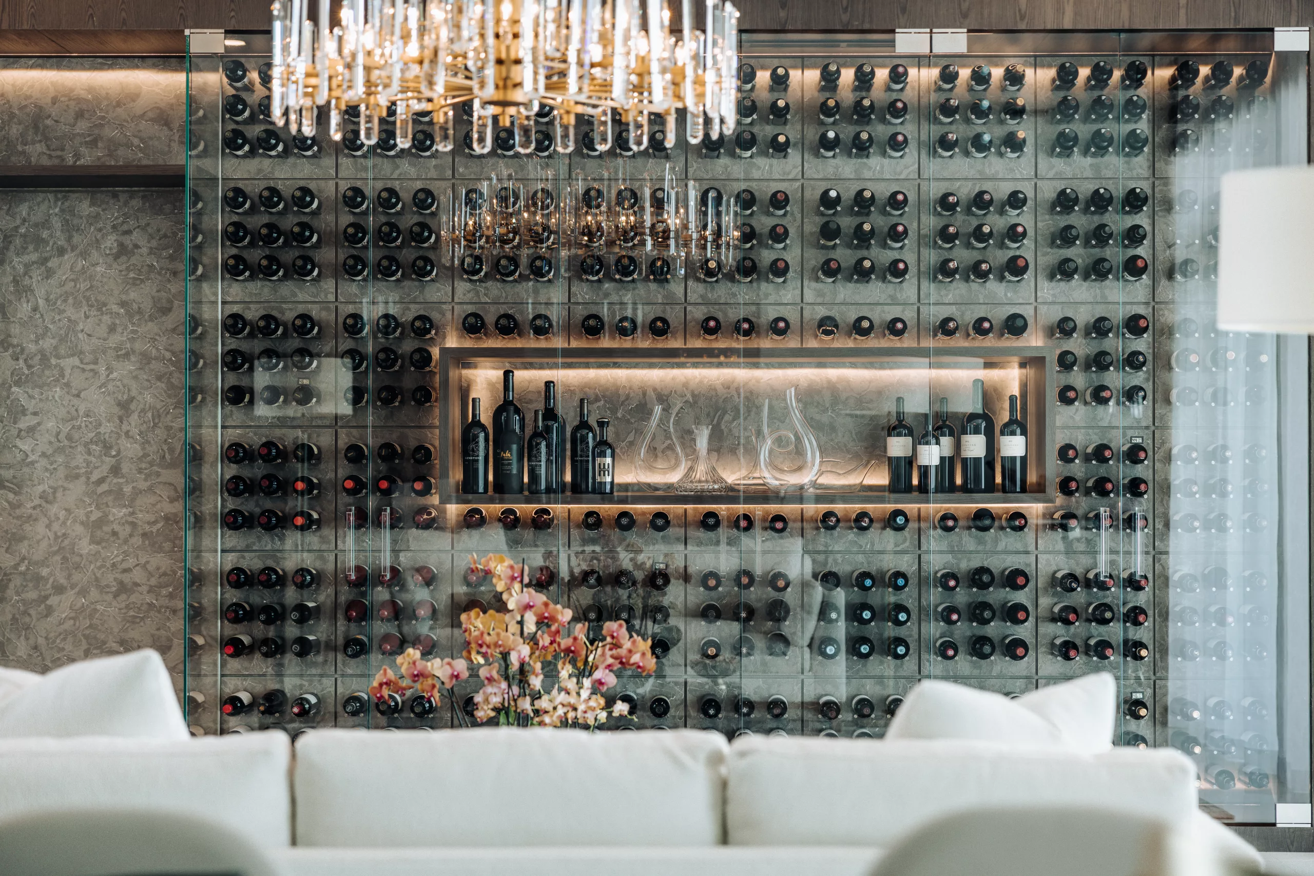 Vino Rails wine display behind a glass wall.