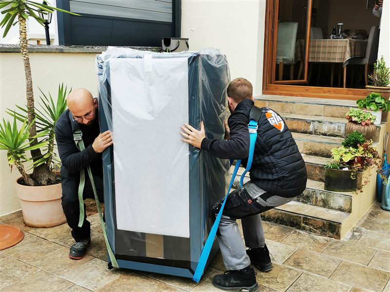 Goguette White Glove Delivery Service shown; lifting fridge with straps