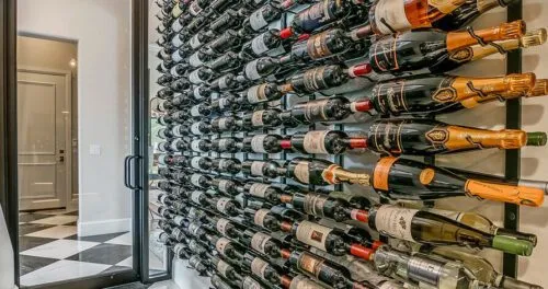 Custom Wine Racks shown in a wine cellar with a glass door.