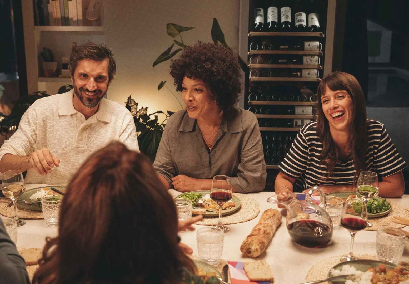 Friends sharing wine around a dinner table