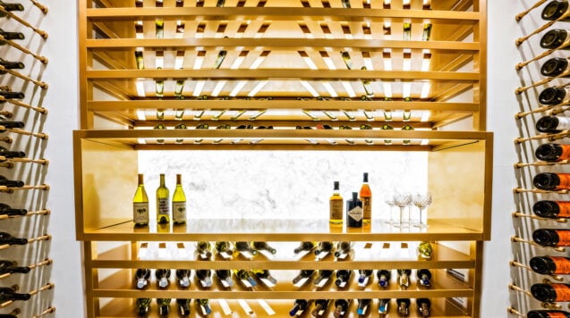 Label-forward wine bottle storage on a custom VintageView Forged racking system, installed by Red Leaf Wine Cellars and Saunas