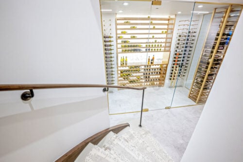 Label-forward wine bottle storage on a custom VintageView Forged racking system, installed by Red Leaf Wine Cellars and Saunas