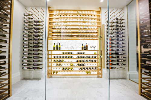 Label-forward wine bottle storage on a custom VintageView Forged racking system, installed by Red Leaf Wine Cellars and Saunas