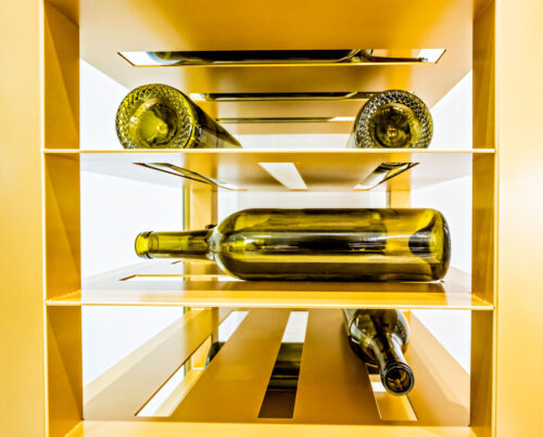 Label-forward wine bottle storage on a custom VintageView Forged racking system, installed by Red Leaf Wine Cellars and Saunas